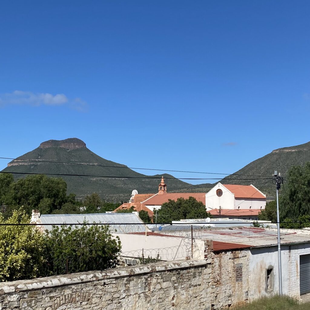 Reference photo of the Karoo landscape near Graaff-Reinet, featuring Spandau Kop, used as inspiration for a painting in a blog post about finding subjects in new environments.